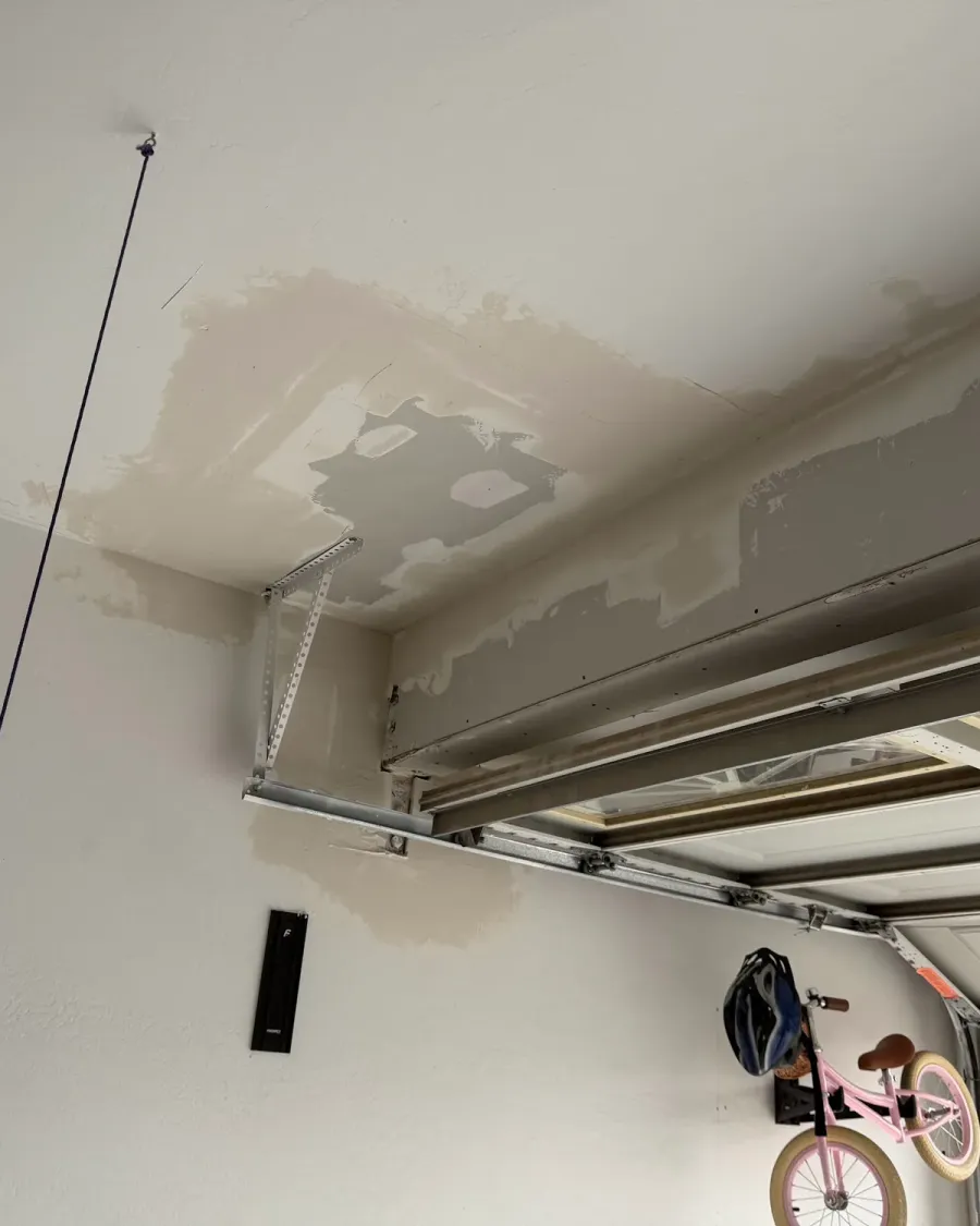 Drywall patches mudded on a garage ceiling
