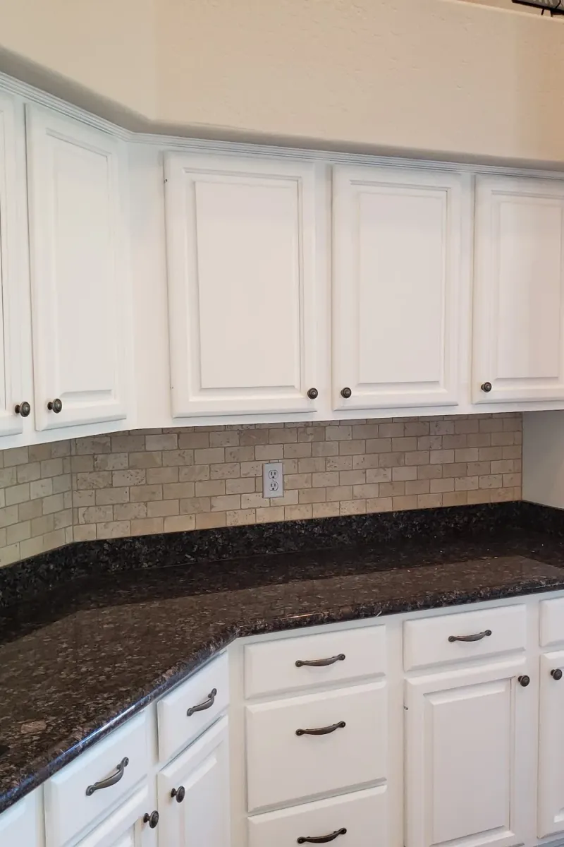 The same kitchen with its cabinets painted white