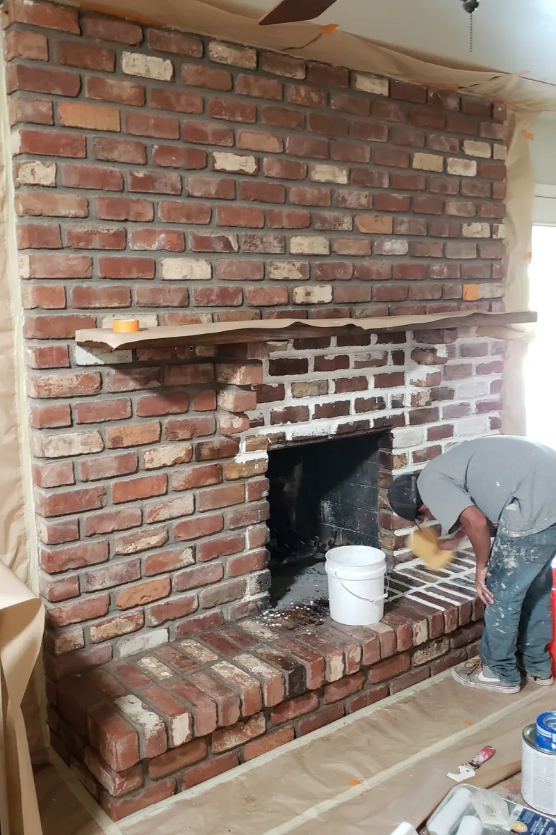 A red brick fireplace wall, before the finish