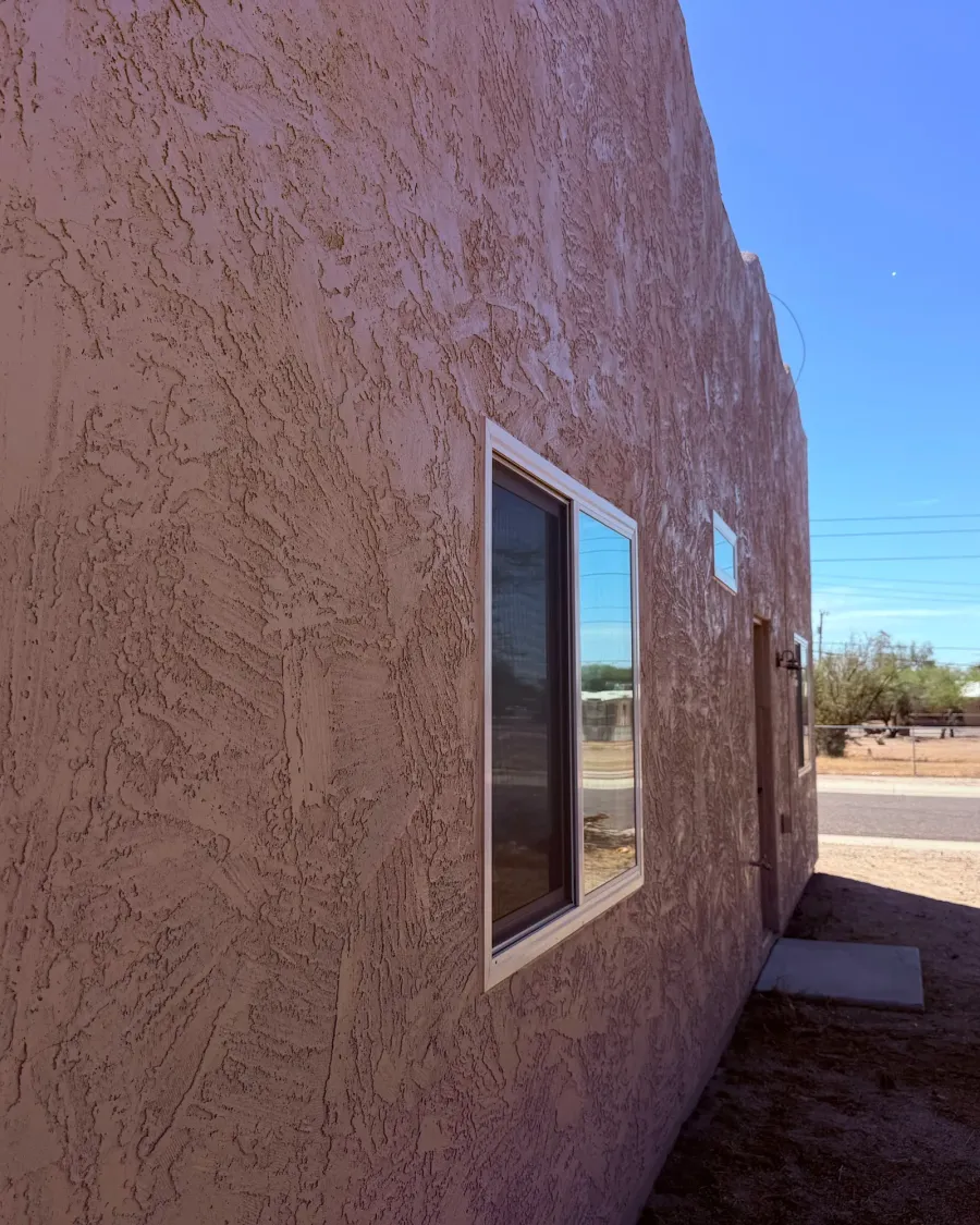 A long stucco wall with an even, freshly finished texture