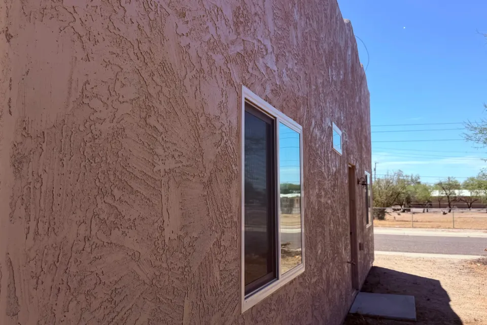 A long stucco wall with an even, freshly finished texture