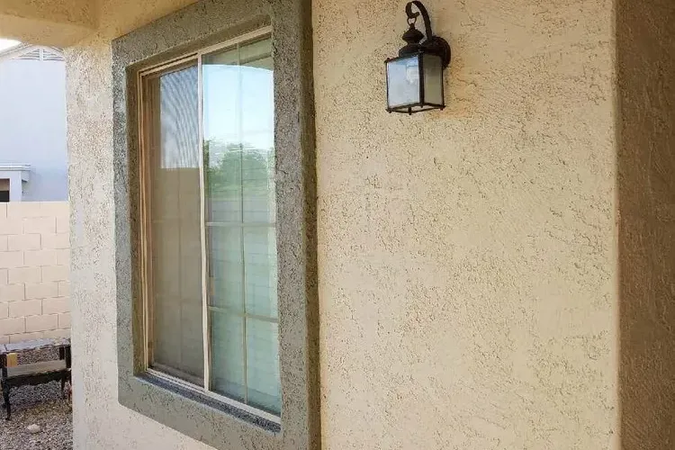Textured stucco wall and window surround on an Arizona home with no visible cracking