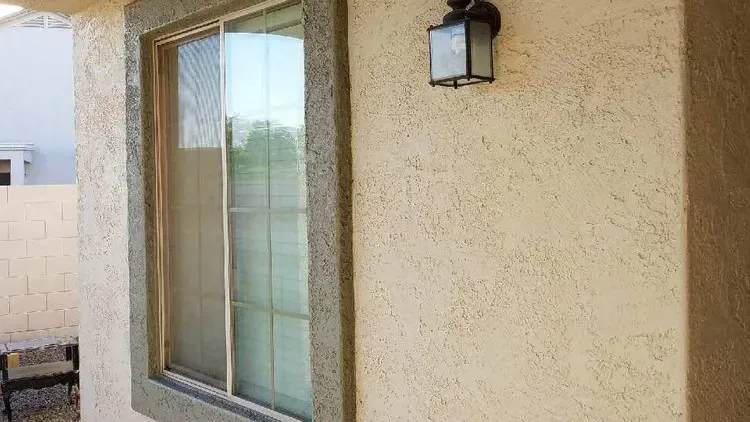 Textured stucco wall and window surround on an Arizona home with no visible cracking