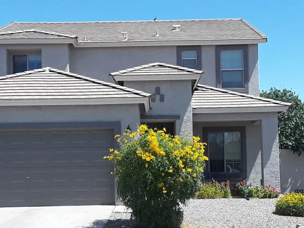 A two-story grey stucco home with a tile roof in Gilbert, Arizona